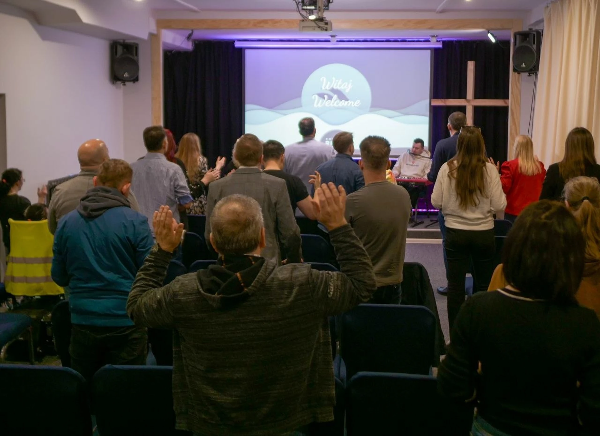 Worship during a River Church Warsaw service