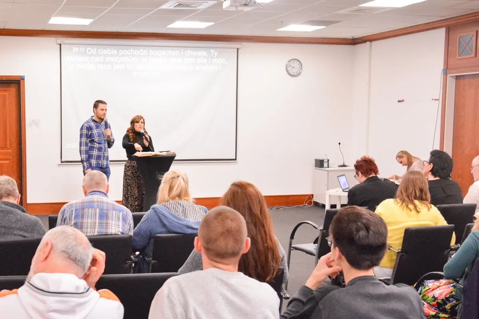 Pastors Michał and Ewelina Glonek teaching during a service